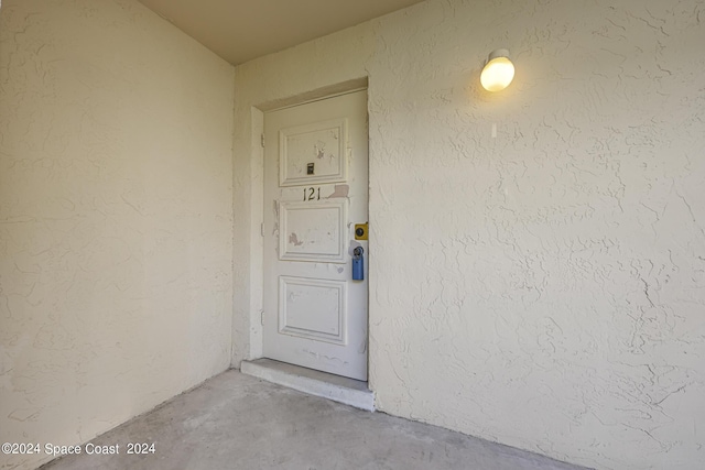 entrance to property featuring stucco siding