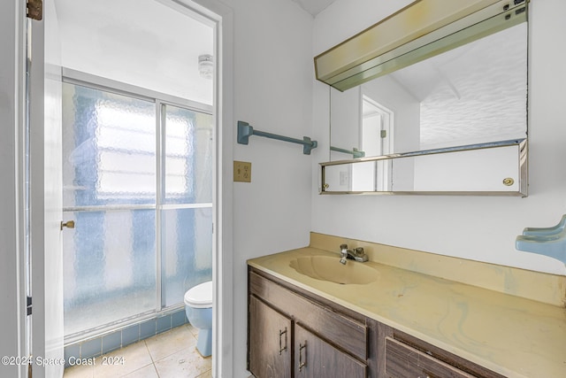 bathroom with vanity, toilet, and tile patterned floors