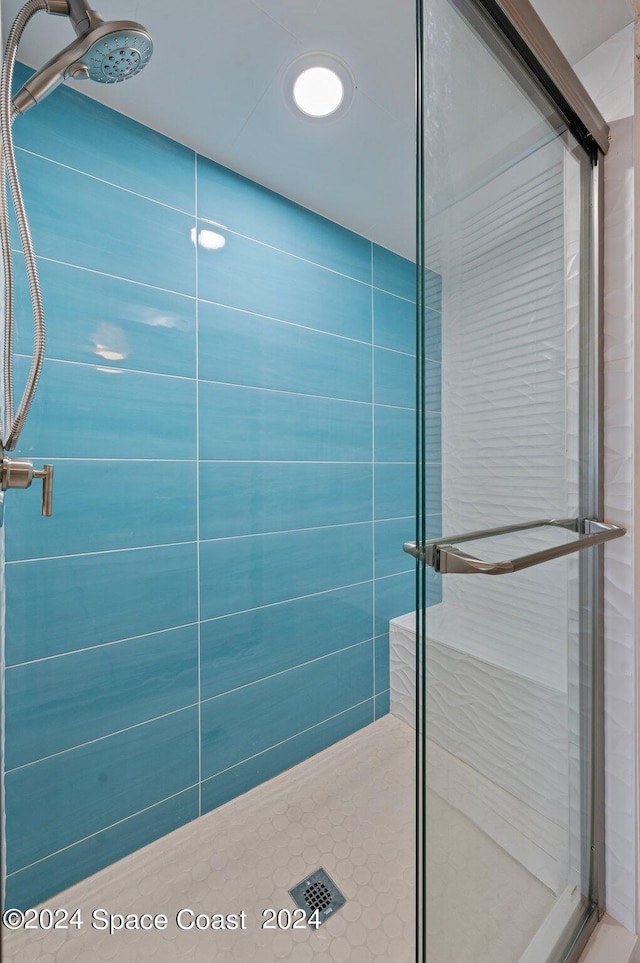 bathroom with a shower with shower door