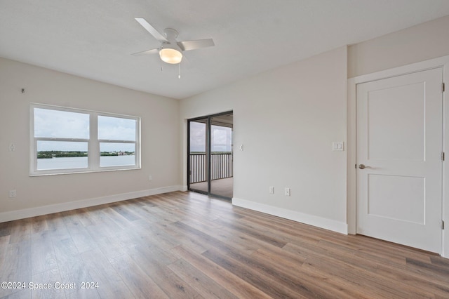 empty room with ceiling fan and hardwood / wood-style floors