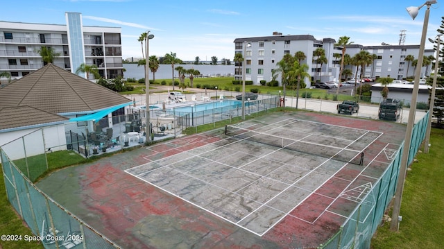 view of sport court with a community pool