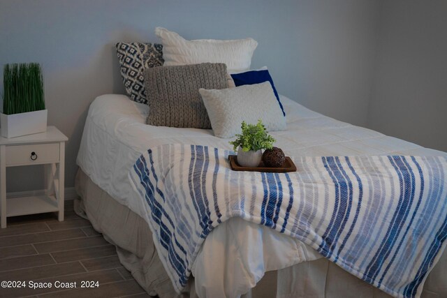 bedroom with dark wood-type flooring