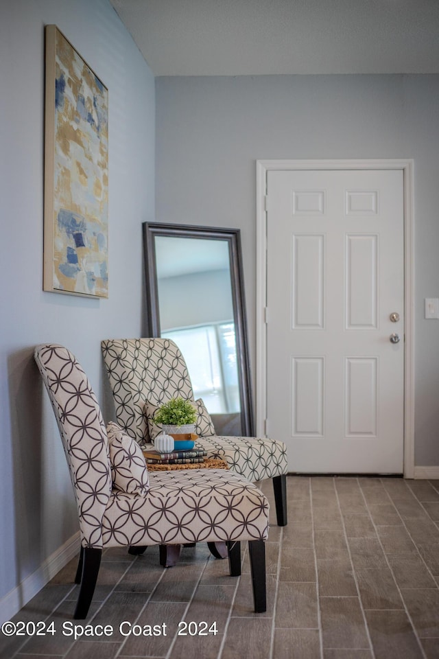 living area featuring baseboards