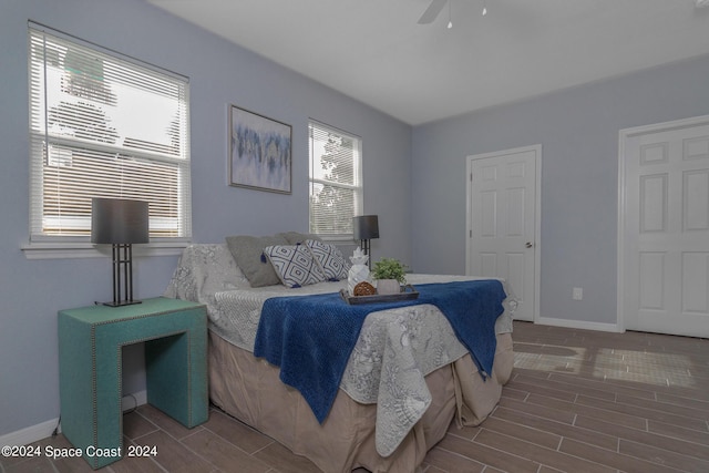 bedroom featuring a ceiling fan, wood finish floors, and baseboards