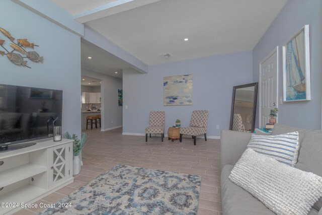 living room featuring beamed ceiling