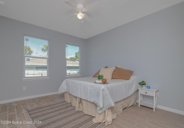 bedroom with light hardwood / wood-style flooring and ceiling fan