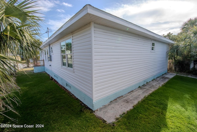 view of property exterior featuring a yard, crawl space, and fence