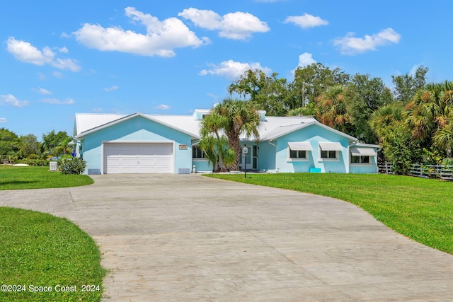 ranch-style home featuring a garage and a front lawn