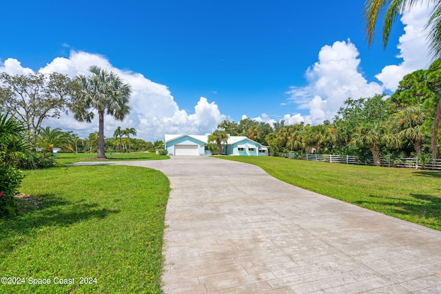 surrounding community featuring a garage and a lawn