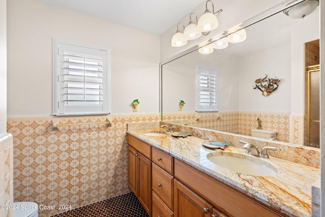 bathroom with plenty of natural light, tile walls, and vanity