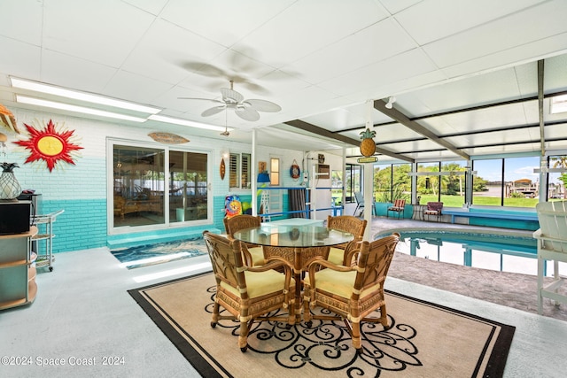 sunroom / solarium featuring ceiling fan and a pool