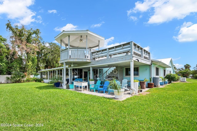 back of property with a lawn, a patio area, an outdoor hangout area, and central air condition unit