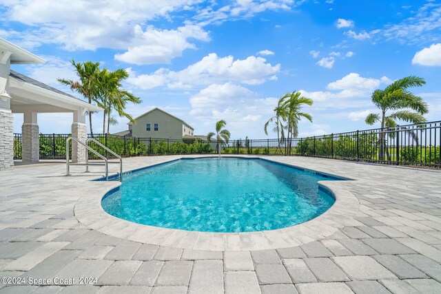 view of swimming pool with a patio, fence, and a fenced in pool