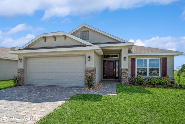 view of front facade with a garage and a front lawn