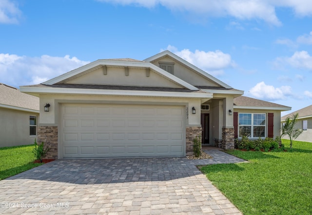 view of front of home featuring stucco siding, decorative driveway, a front lawn, and stone siding