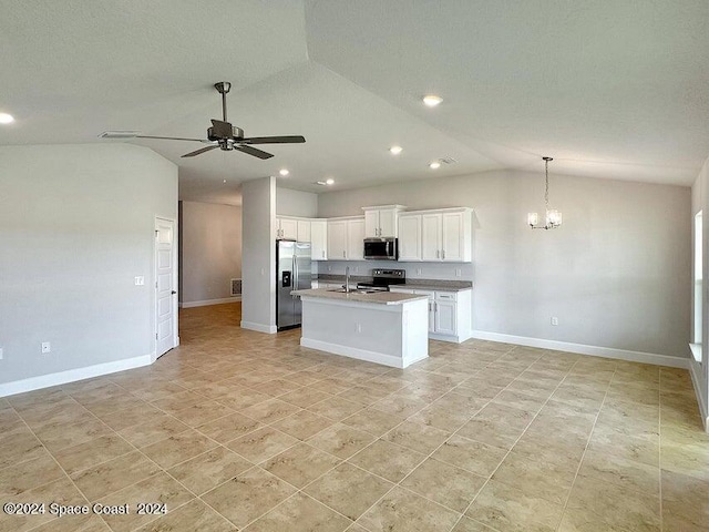 kitchen with white cabinetry, stainless steel appliances, and lofted ceiling