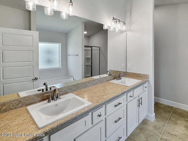 bathroom with tile patterned flooring, independent shower and bath, and vanity