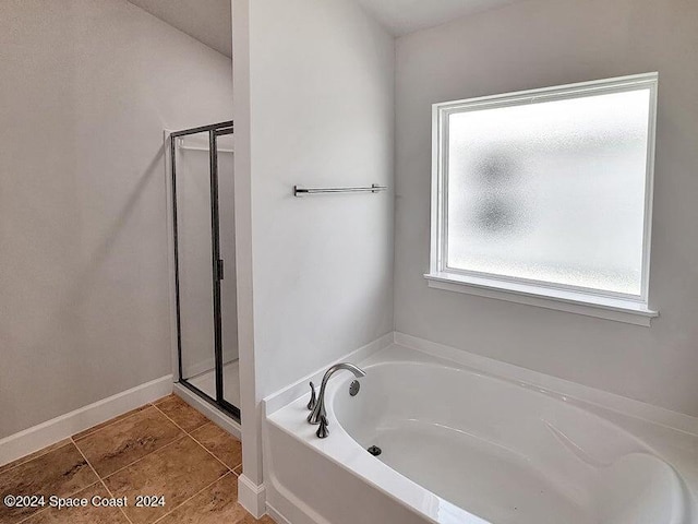 bathroom with independent shower and bath and tile patterned floors