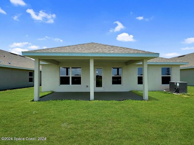 back of property featuring cooling unit, a lawn, and a patio