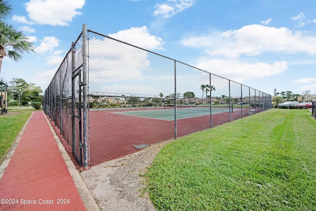 view of sport court featuring a yard