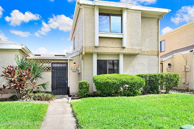 1030 Abada Ct NE Unit 102, Palm Bay, FL 32905 - multi unit property featuring stucco siding and a front yard