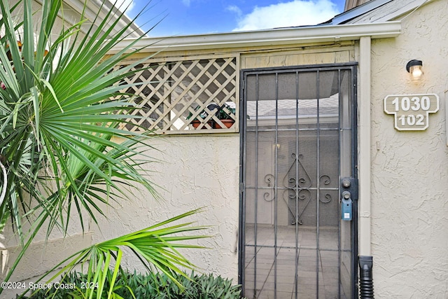 1030 Abada Ct NE Unit 102, Palm Bay, FL 32905 - property entrance with stucco siding