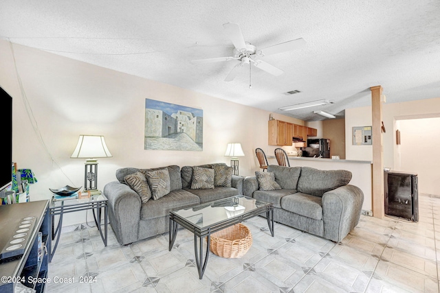 1030 Abada Ct NE Unit 102, Palm Bay, FL 32905 - living room featuring a ceiling fan and a textured ceiling