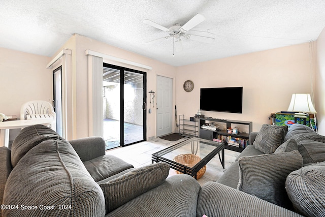 1030 Abada Ct NE Unit 102, Palm Bay, FL 32905 - living room featuring a ceiling fan and a textured ceiling