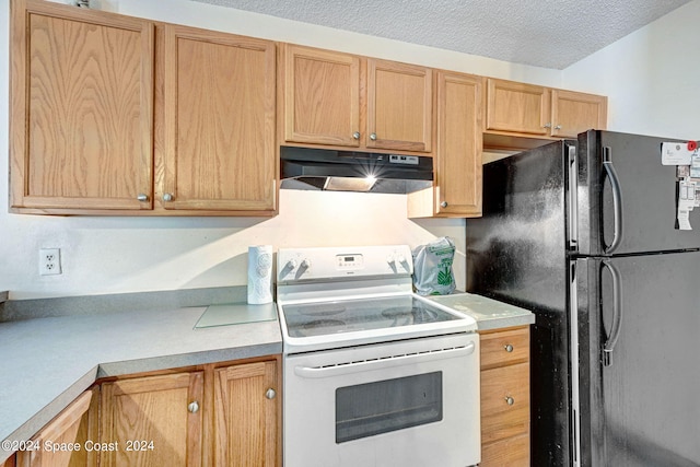 kitchen featuring a textured ceiling, black refrigerator, and white range with electric stovetop