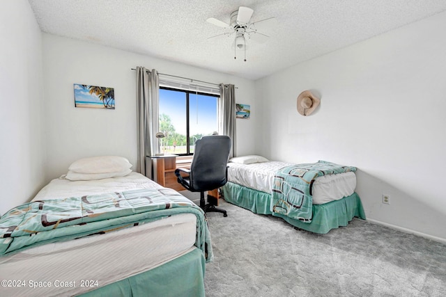 1030 Abada Ct NE Unit 102, Palm Bay, FL 32905 - bedroom featuring carpet flooring, a textured ceiling, and a ceiling fan
