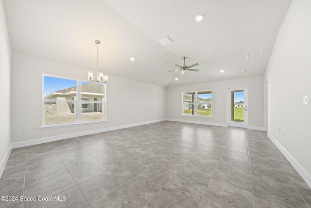 unfurnished room with ceiling fan with notable chandelier and light tile patterned flooring