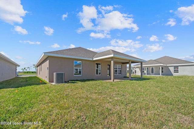 back of house with a lawn and central AC