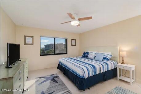 bedroom with light colored carpet and ceiling fan