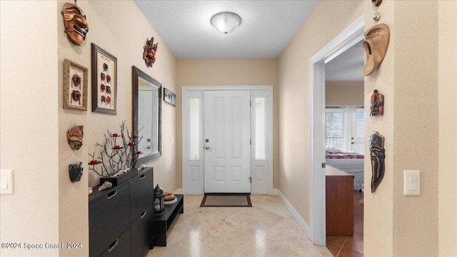 foyer entrance featuring a textured ceiling