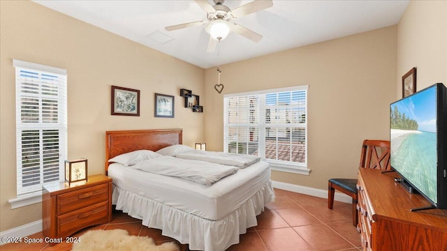 tiled bedroom featuring ceiling fan