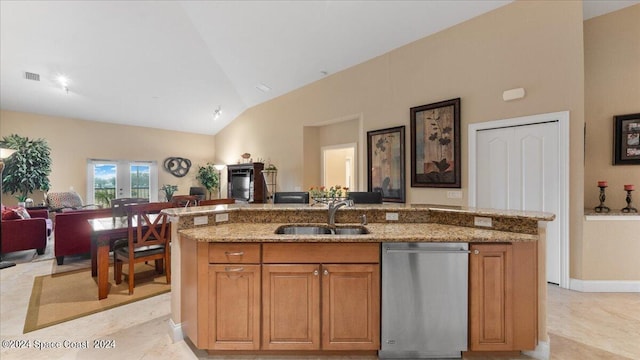 kitchen with an island with sink, sink, light stone countertops, lofted ceiling, and stainless steel dishwasher