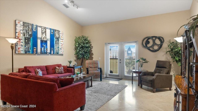 living room featuring concrete floors, french doors, and track lighting