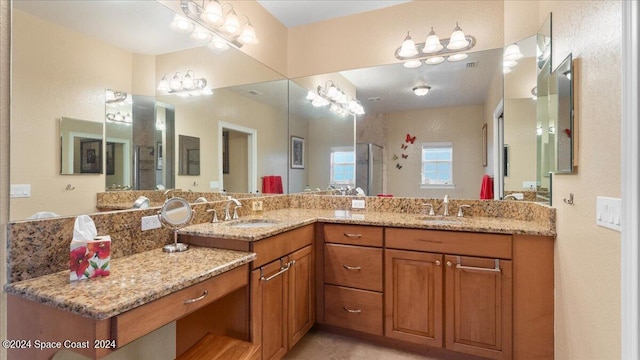 bathroom featuring a shower with shower door and vanity