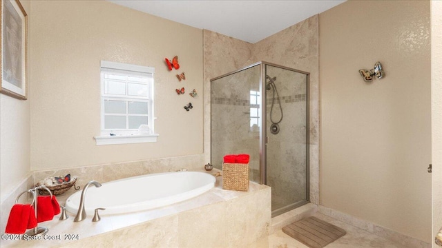 bathroom with tile patterned flooring and independent shower and bath