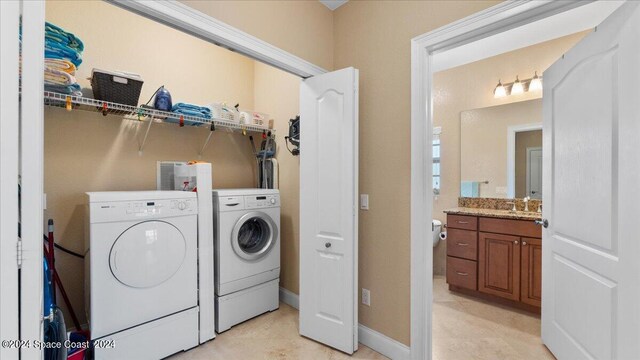 washroom with washer and clothes dryer and sink