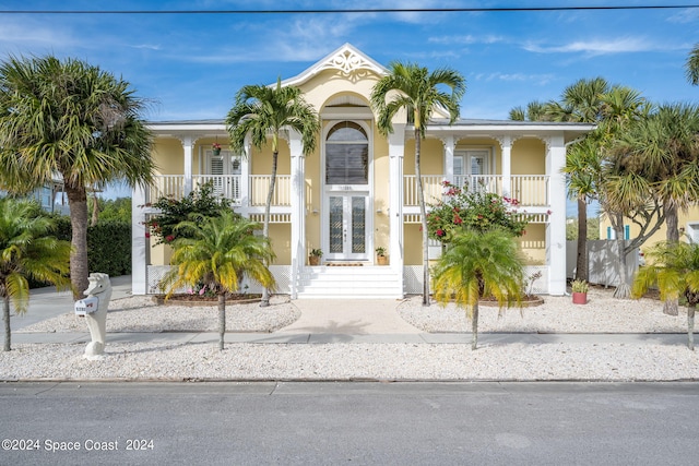5280 95th St, Sebastian, FL 32958 - view of front facade with french doors, a porch, and stucco siding