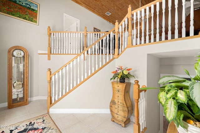 5280 95th St, Sebastian, FL 32958 - stairs featuring tile patterned flooring, wooden ceiling, and high vaulted ceiling