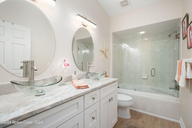 5280 95th St, Sebastian, FL 32958 - full bathroom featuring tiled shower / bath combo, wood finished floors, and double vanity