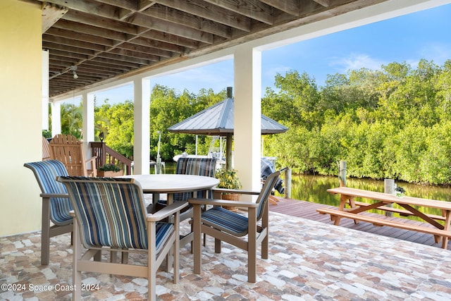 5280 95th St, Sebastian, FL 32958 - view of patio / terrace featuring outdoor dining space and view of wooded area