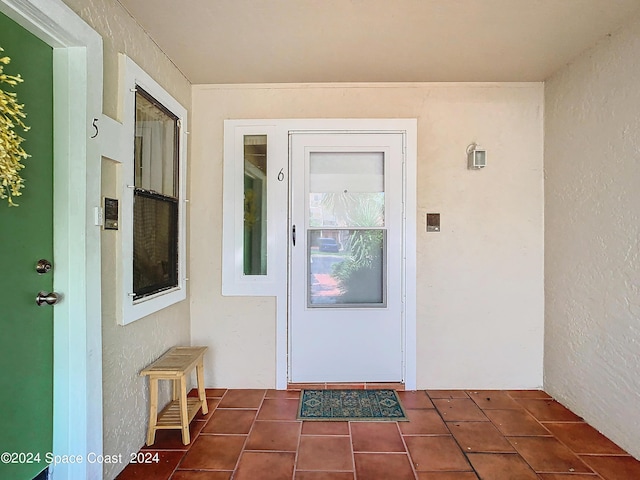 entrance to property featuring stucco siding