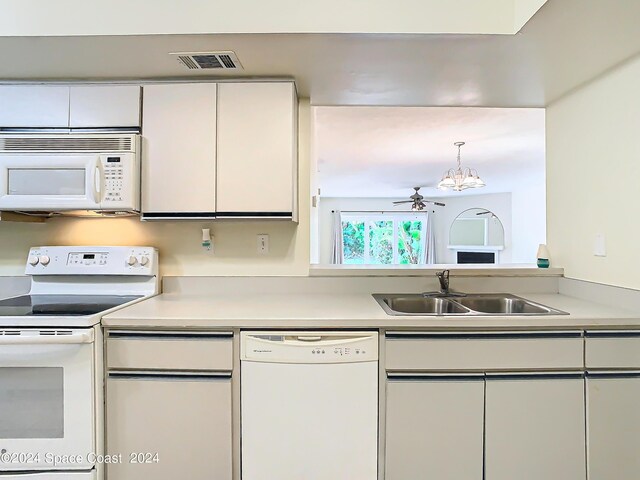 kitchen with white cabinets, white appliances, and sink