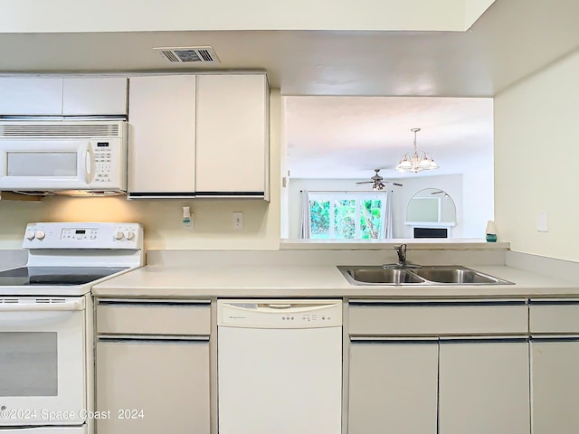 kitchen with white appliances, visible vents, light countertops, and a sink