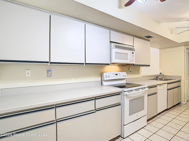 kitchen with white appliances, light tile patterned flooring, sink, ceiling fan, and white cabinets