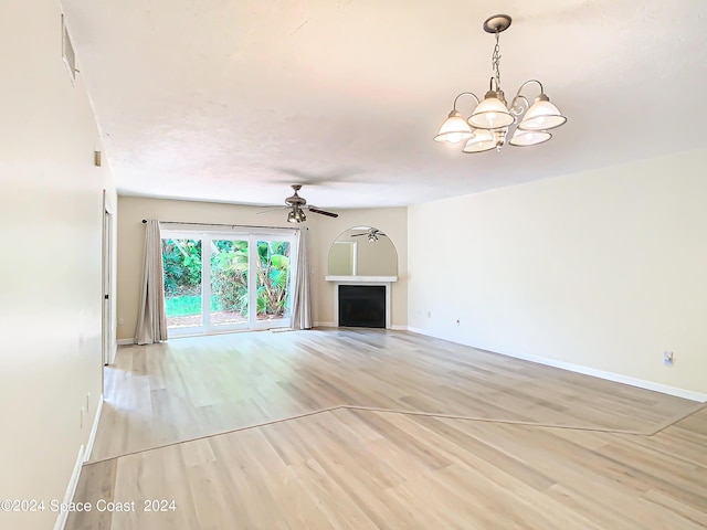 unfurnished living room with light wood-type flooring, a fireplace, and baseboards