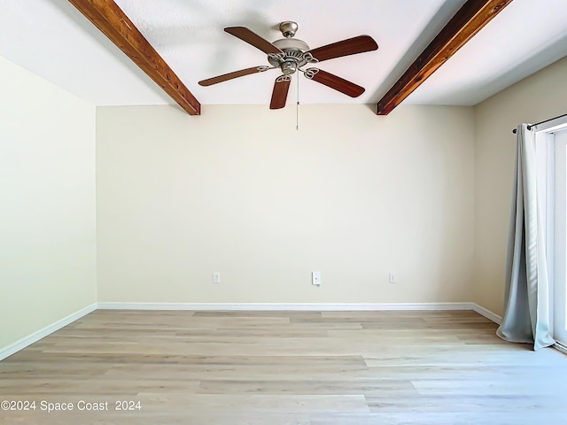 unfurnished room featuring light wood-type flooring, ceiling fan, baseboards, and beamed ceiling